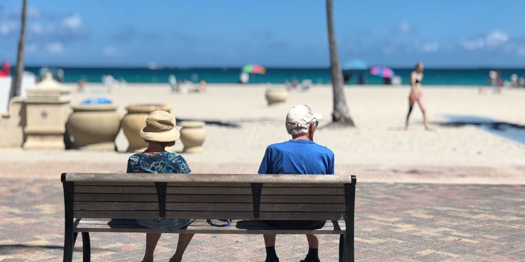 seniors on bench at the beach